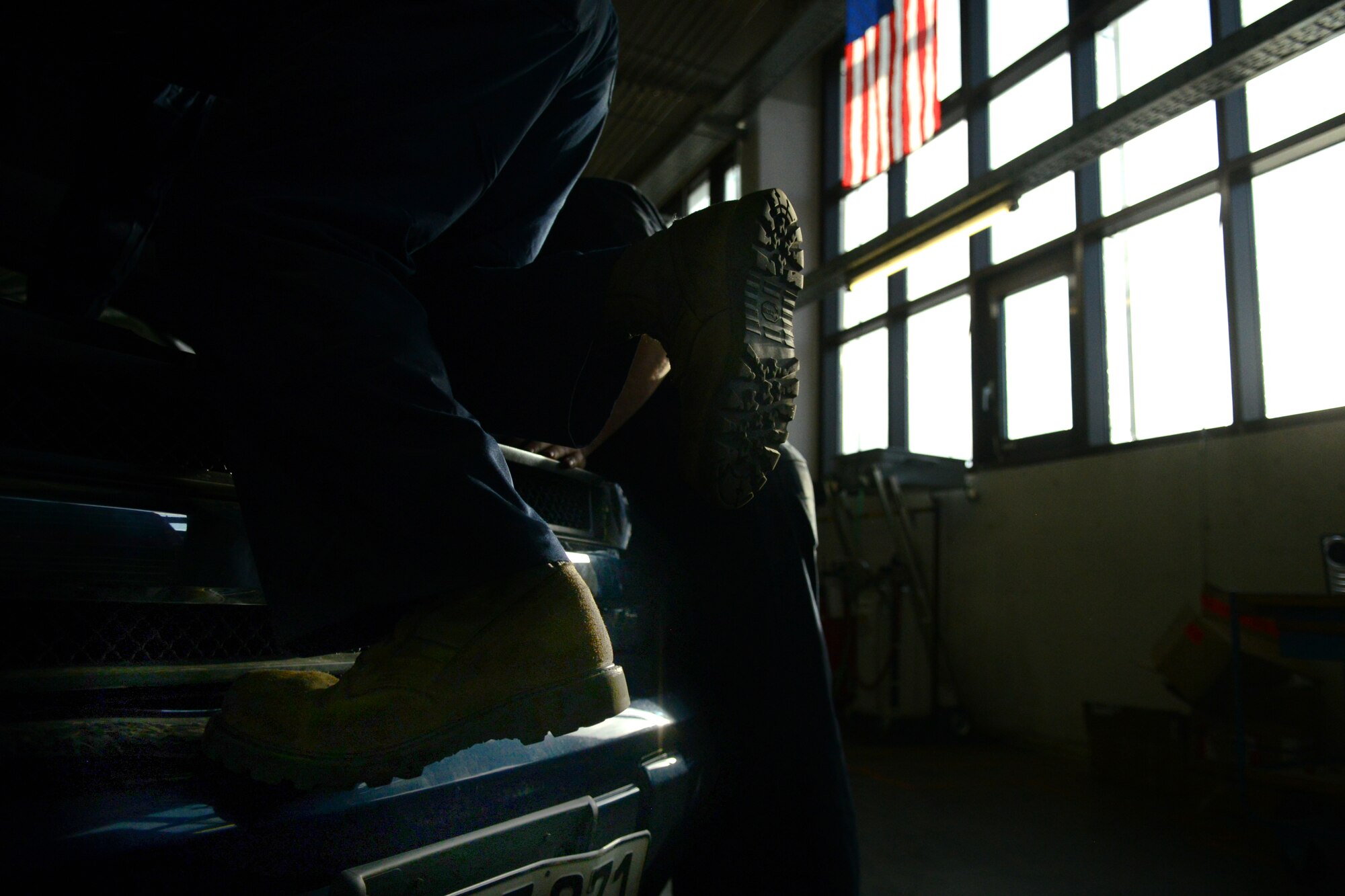 Airman 1st Class Shawn Hancock, 86th Vehicle Readiness Squadron general purpose light vehicle mechanic, climbs onto a truck at Ramstein Air Base, Germany, Jan. 14, 2015. The 86th VRS is responsible for servicing more than 1000 vehicles on and off base. (U.S. Air Force photo by Senior Airman Nicole Sikorski/Released) 