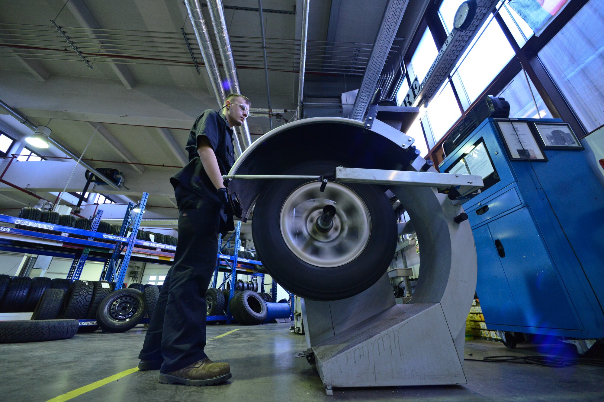 Airman 1st Class Austin Conway, 86th Vehicle Readiness Squadron general purpose light vehicle mechanic, checks the pressure in a tire at Ramstein Air Base, Germany, Jan. 14, 2015.  The 86th VRS is responsible for servicing more than 1000 vehicles on and off base. (U.S. Air Force photo by Senior Airman Nicole Sikorski/Released) 