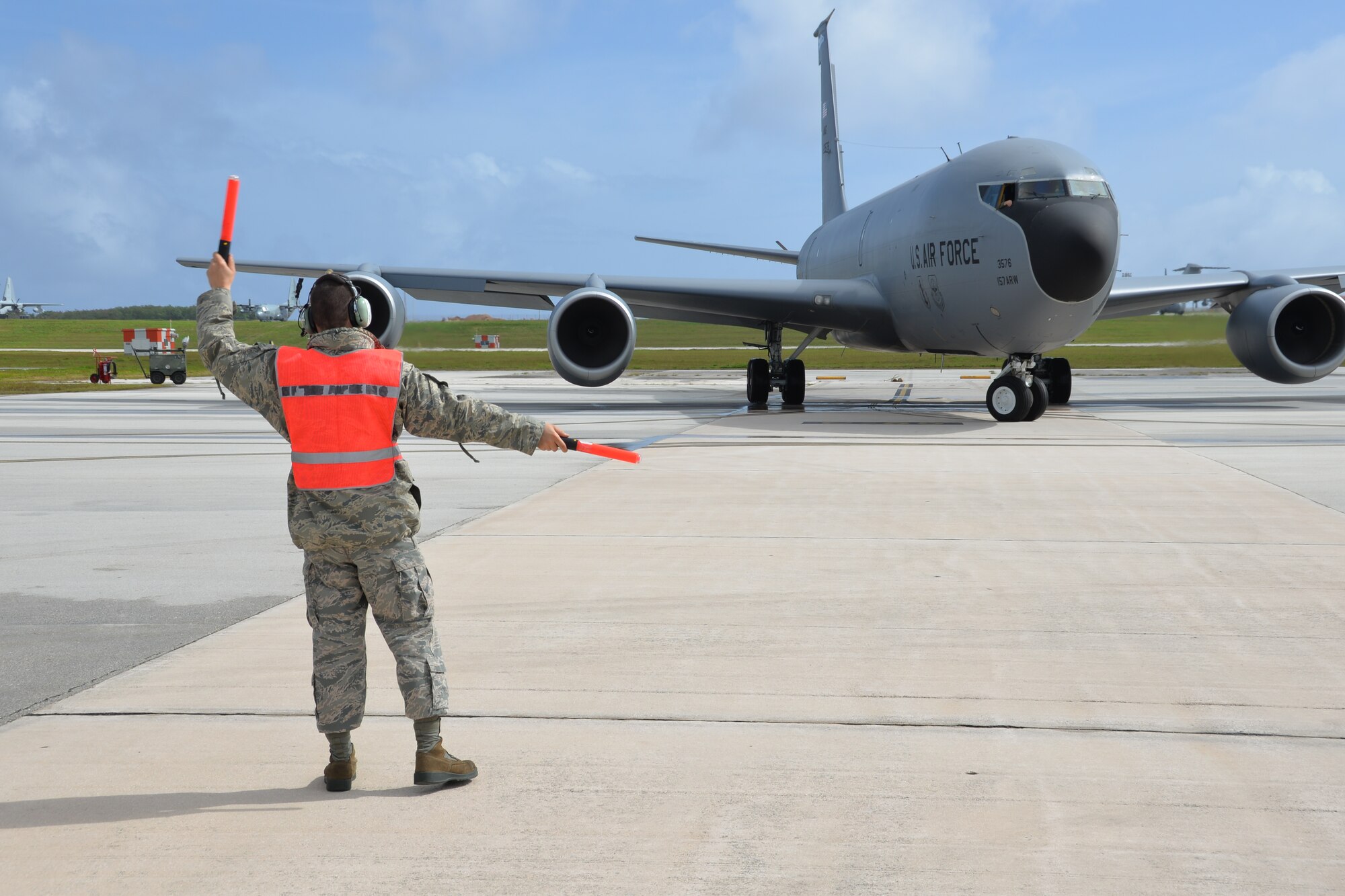 Airman 1st Class William Rand, 506th Expeditionary Air Refueling Squadron Aircraft Maintenance assistant crew chief, marshals a KC-135R piloted by Lt. Col. Jason Denton, aircraft commander, as the tanker departs on a training mission over the western pacific.  The tanker and Airman are deployed to Guam from Pease Air National Guard Base, New Hampshire. (U.S. Air National Guard photo by Tech. Sgt. Thomas Johnson)