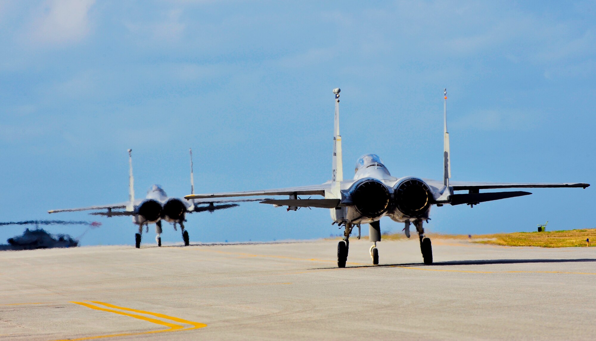 Two U.S. Air Force F-15C Eagles prepare to take off during a training surge on Kadena Air Base, Japan, Jan. 15, 2015. The surge allows the unit to get ahead of the flying-hour program and gives them the ability to test their maximum production capacity. (U.S. Air Force photo by Naoto Anazawa)
