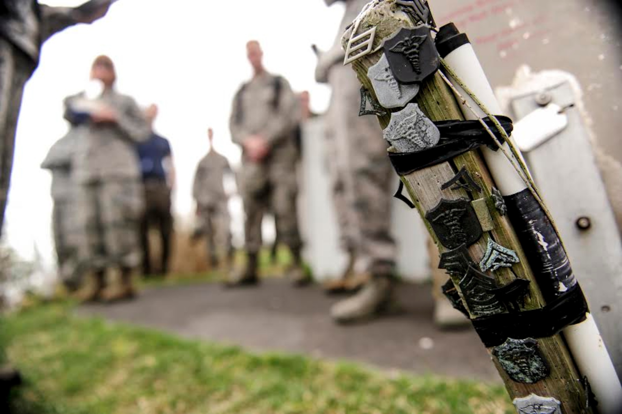 Rank and occupational badges of Marines and Naval corpsmen are affixed to a PVC pipe on top of Mount Suribachi on Iwo To, Japan, Jan, 8, 2015. They were left in honor of the participants in the battle of Iwo Jima, near the site where the American flag was raised. (U.S. Air Force photo by Airman 1st Class John Linzmeier) 