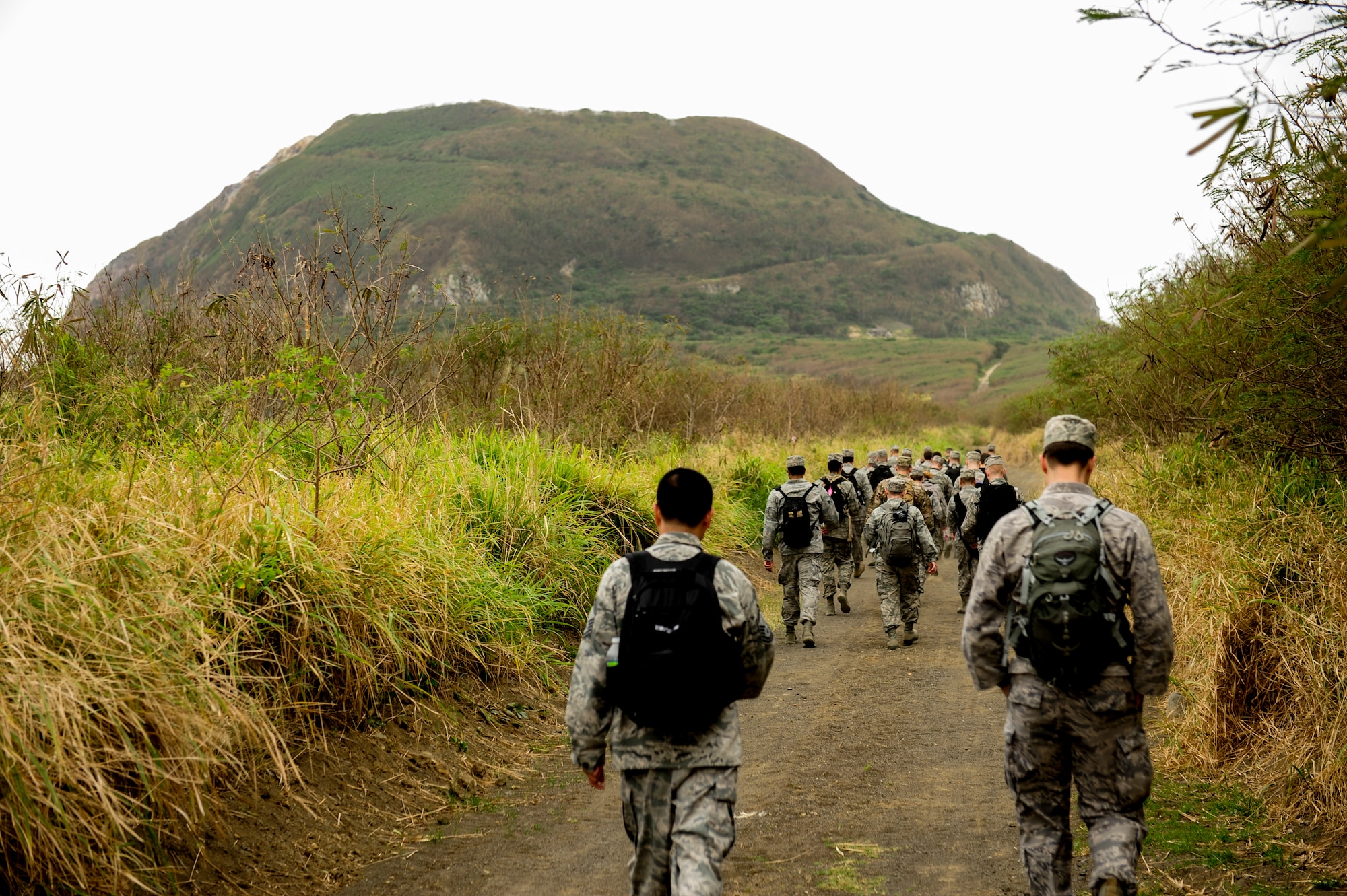 Airmen from Kadena Air Base, Japan, hike toward Mount Suribachi on Iwo To, Japan Jan. 8, 2015. They visited Iwo To as part of a professional military education outing to learn about the battle of Iwo Jima that took place nearly 70 years ago. (U.S. Air Force photo by Airman 1st Class John Linzmeier)