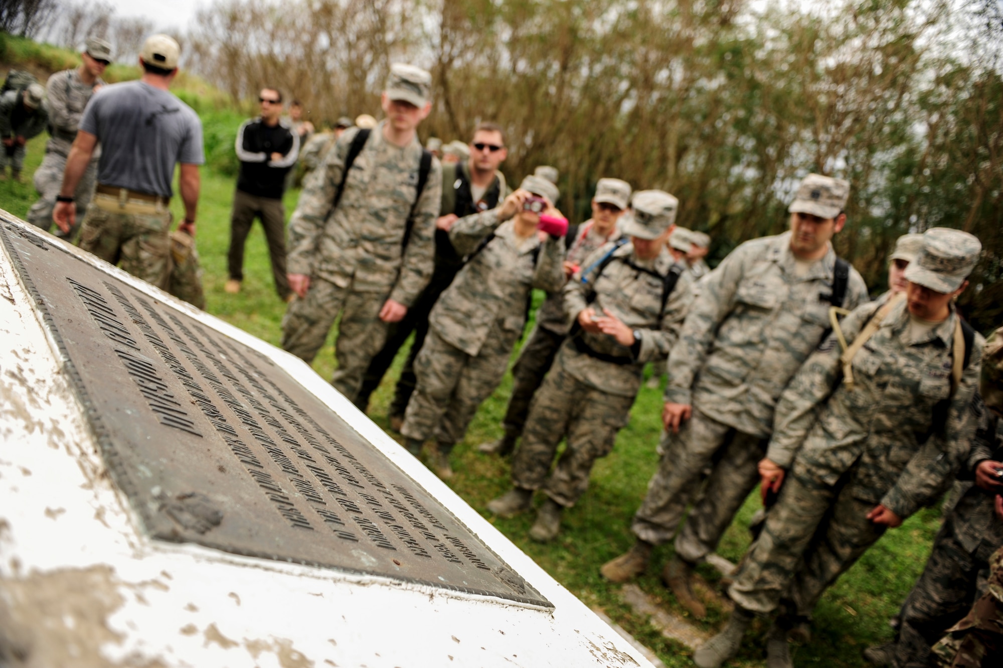 Airmen from Kadena Air Base, Japan, gather around a World War II memorial on Iwo To, Japan Jan. 8, 2015. They visited the island for a day to see the battleground, once known as Iwo Jima, of the largest assault in U.S. Marine Corps history. More than 6,800 Marines died over a period of 36 days. (U.S. Air Force photo by Airman 1st Class John Linzmeier)