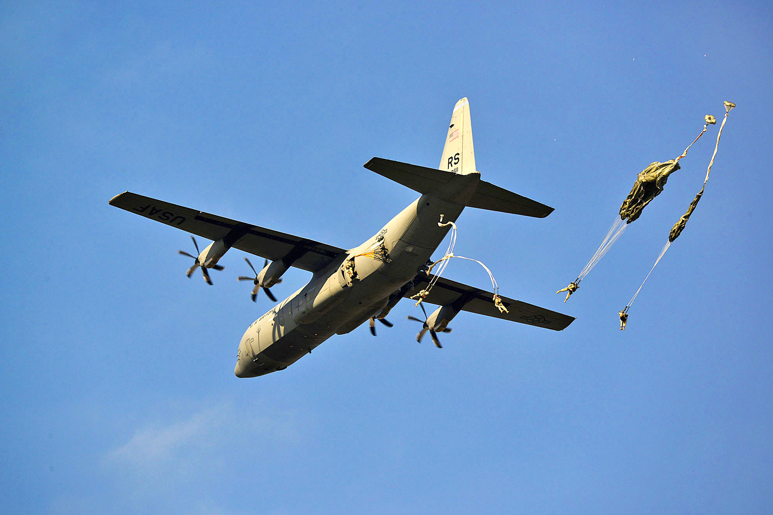 U.S. paratroopers jump from a C-130 Hercules aircraft over Juliet drop zone  in Pordenone, Italy