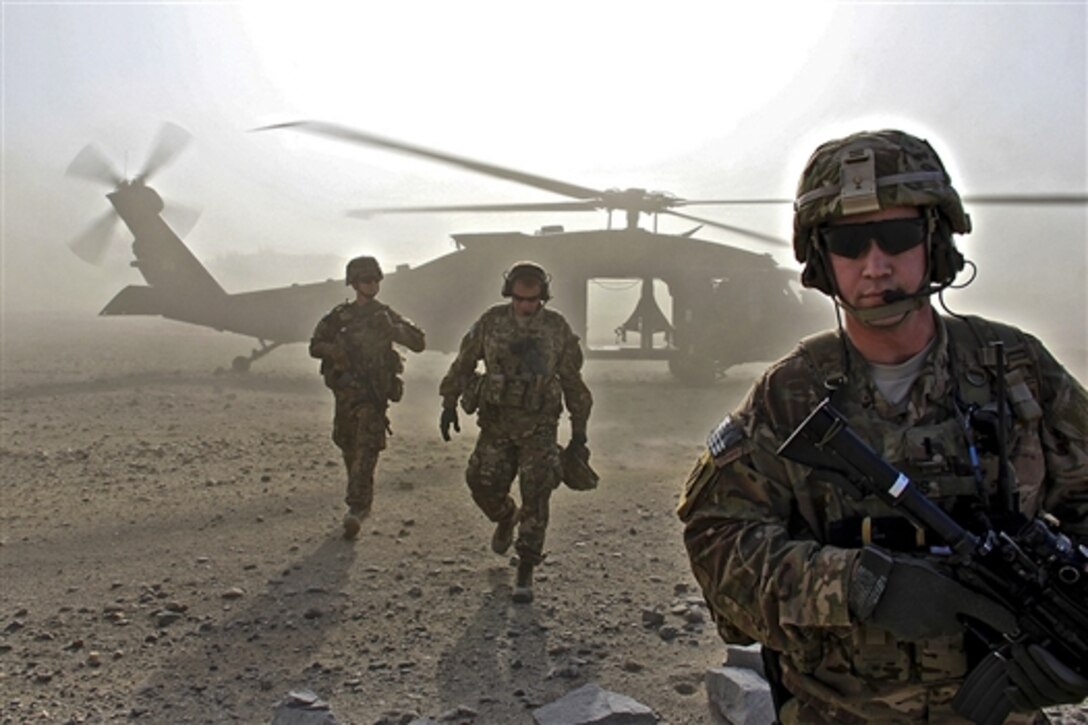 U.S. Army Spc. John Gilbert, left, U.S. Army Brig. Gen. Christopher Bentley, center, commander of Train, Advise, Assist Command East, and U.S. Army 1st Lt. Steven Sanders depart a UH-60 Black Hawk helicopter in Afghanistan's Nangarhar province, Jan. 6, 2015. Gilbert and Sanders are assigned to the 3rd Cavalry Regiment, Train, Advise, Assist Command East. 