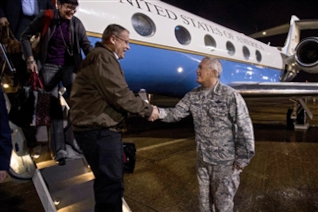 Deputy Defense Secretary Bob Work shakes hands with Air Force Lt. Gen. William H. Etter, commander of the Continental U.S. North American Aerospace Defense Command Region, known as CONR, as he arrives on Tyndall Air Force Base, Fla., Jan. 15, 2015. Work plans to meet with senior leaders and service members on base and at Naval Support Activity Panama City. 