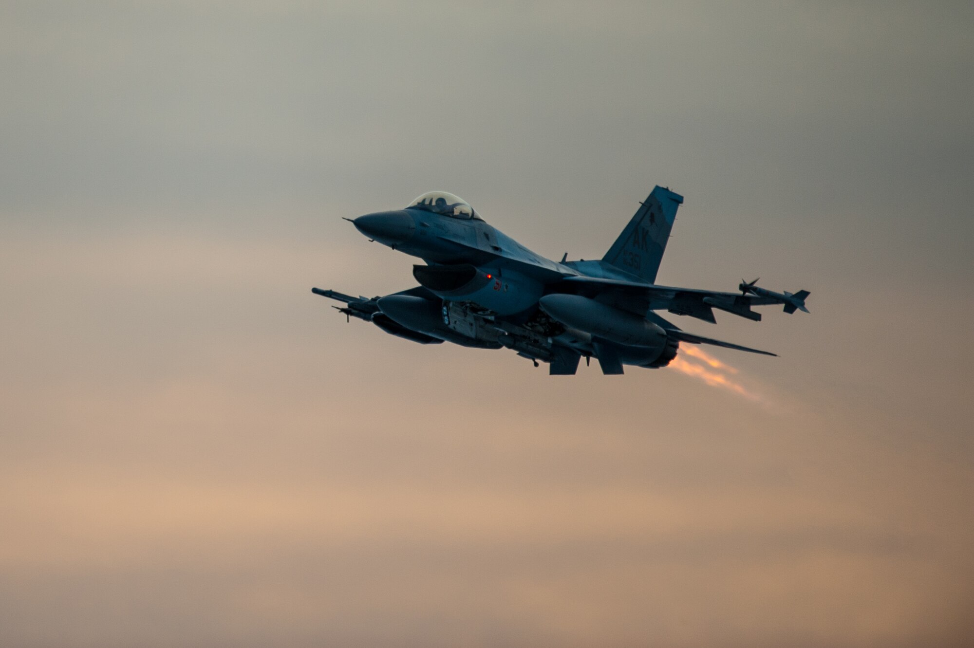 One of 14 U.S. Air Force F-16 Fighting Falcon aircraft with the 18th Aggressor Squadron takes off from Eielson Air Force Base, Alaska, shortly after sunrise Jan. 17, 2015, in transit to Hickam Air Force Base, Hawaii, and Andersen Air Force Base, Guam to participate in the SENTRY ALOHA and COPE NORTH exercises. More than 150 maintainers will keep the Aggressors in the air during the exercises, which are meant to prepare U.S. Airmen, Sailors and Marines along with coalition partners in the Pacific theater of operations for contingency operations if the need arises.  (U.S. Air Force Photo by Tech. Sgt. Joseph Swafford/Released)
