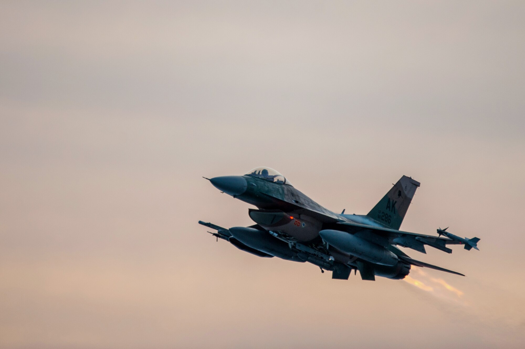 One of 14 U.S. Air Force F-16 Fighting Falcon aircraft with the 18th Aggressor Squadron takes off from Eielson Air Force Base, Alaska, shortly after sunrise Jan. 17, 2015, in transit to Hickam Air Force Base, Hawaii, and Andersen Air Force Base, Guam to participate in the SENTRY ALOHA and COPE NORTH exercises. More than 150 maintainers will keep the Aggressors in the air during the exercises, which are meant to prepare U.S. Airmen, Sailors and Marines along with coalition partners in the Pacific theater of operations for contingency operations if the need arises.  (U.S. Air Force Photo by Tech. Sgt. Joseph Swafford/Released)
