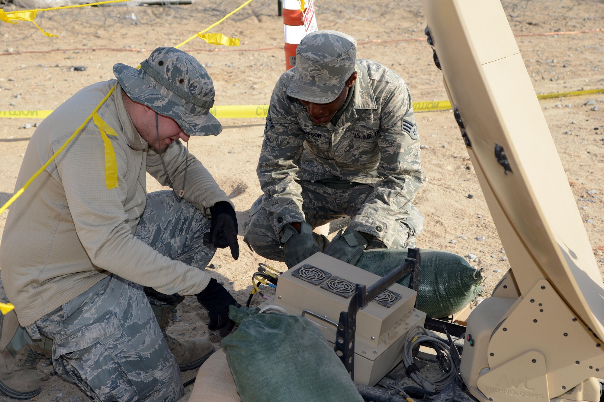 Airmen from the 332nd Expeditionary Communications Squadron operations flight work on a satellite as part of building up the communications infrastructure for the 332nd Air Expeditionary Group here Jan. 11. The advance team arrived in November with six personnel and set up the communications initial operating capability. Within three days of the rest of the unit’s arrival, the combat communications squadron increased the network capacity from 20 users to more than 150.