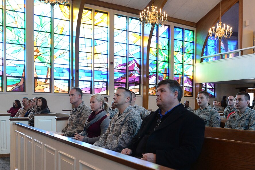 Col. Michael A. Vogel, and his wife, Misty, Command Chief Master Sgt. Craig A. Poling and Thomas Frederick attend a celebration to remember the life of Dr. Martin Luther King, Jr. at the base chapel Jan. 16. The event featured an "I Have a Dream" speech reenactment by Timothy Martin, 66th Security Forces Squadron, and special music performance. (U.S. Air Force photo by Jerry Saslav)