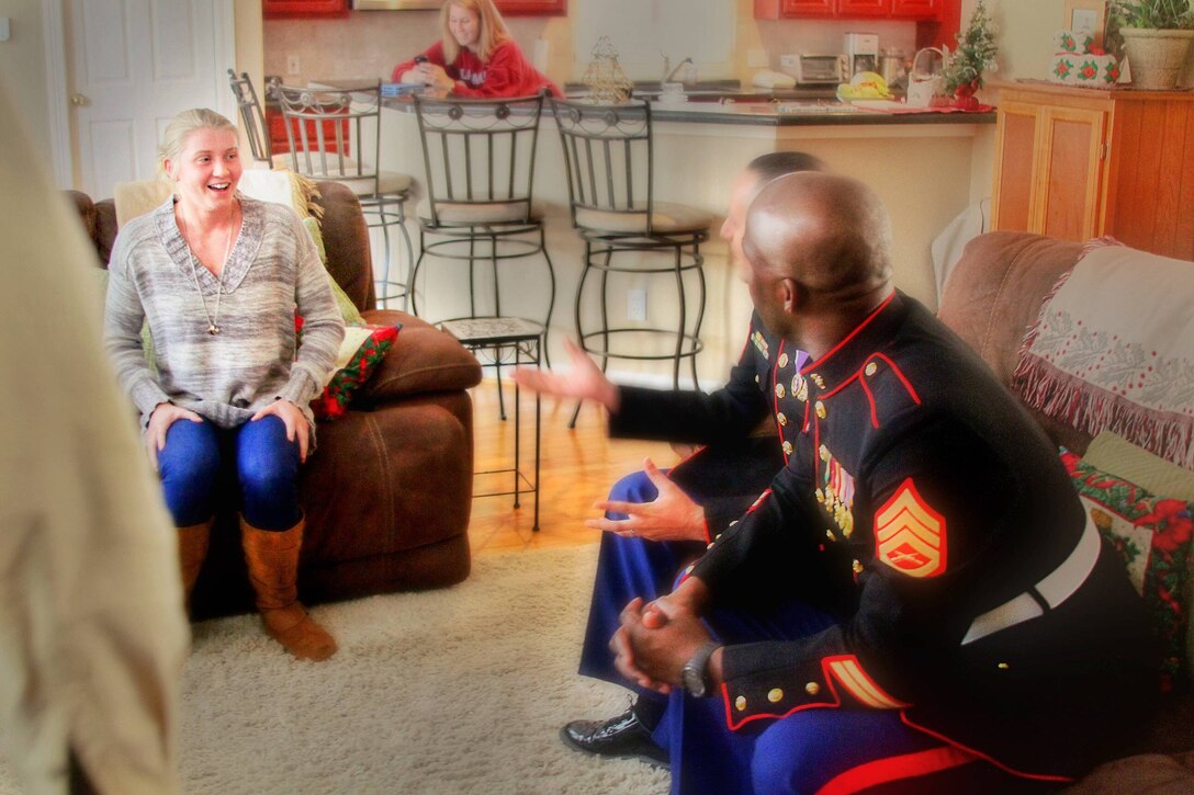Michelle Matthews, at 17-year-old native of Kingwood, Texas, and student at Kingwood High School, sits in shock after Marine Staff Sgt. Jesse Beaubrun and Sgt. Mina Mechreki with Recruiting Station Houston gave her the surprise of her life. Beaubrun and Mechreki came to her home New Year’s Eve to congratulate her on being accepted to receive the Marine Corps NROTC Scholarship.  Matthews will receive a check for $150,000 to go toward attaining her degree in civil engineering. Michelle said she feels blessed and is excited to begin her life-long dream of becoming a United States Marine. (U.S. Marine Corps Photo by Sgt. Gabrielle Bustos)