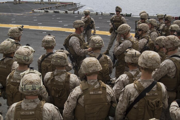 Marines from the 24th Marine Expeditionary Unit receive a safety brief before participating in a live-fire exercise aboard the amphibious assault ship USS Iwo Jima (LHD 7), Jan. 18, 2015. The 24th MEU is embarked on the ships of the Iwo Jima Amphibious Ready Group and deployed to maintain regional security in the U.S. 5th Fleet area of operations. (U.S. Marine Corps photo by Lance Cpl. Dani A. Zunun)