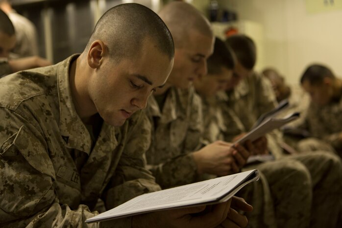 Lance Cpls. with Kilo Company, Battalion Landing Team 3rd Battalion, 6th Marine Regiment, 24th Marine Expeditionary Unit, read an article during  a Lance Corporal’s Leadership and Ethics Seminar aboard the amphibious dock landing ship USS Fort McHenry (LSD 43), Jan. 14, 2015. The 24th MEU is embarked on the ships of the Iwo Jima Amphibious Ready Group and deployed to maintain regional security in the U.S. 5th Fleet area of operations. (U.S. Marine Corps photo by Sgt. Devin Nichols)