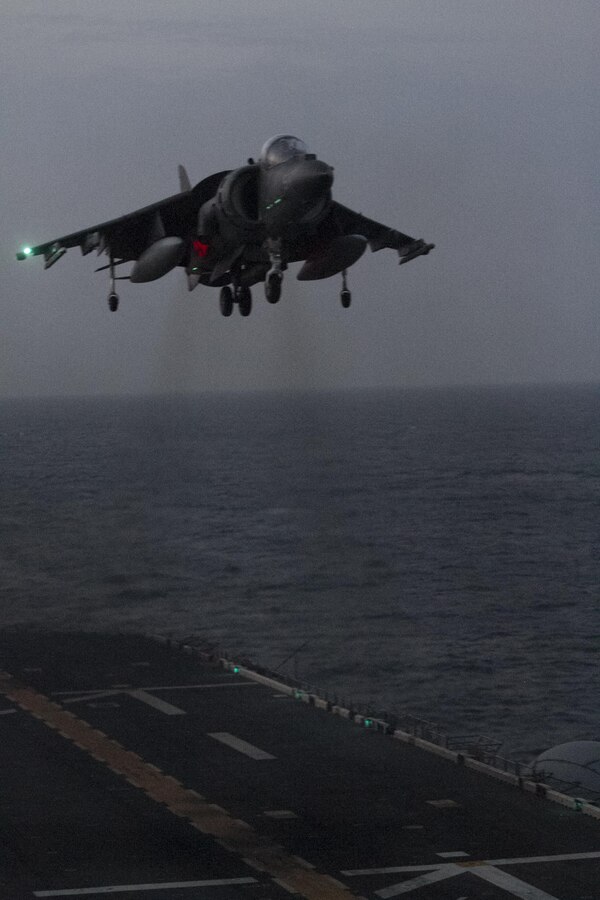 An AV-8B Harrier Jump jet from Marine Medium Tiltrotor Squadron 365 (Reinforced), 24th Marine Expeditionary Unit, conducts a vertical landing aboard the amphibious assault ship USS Iwo Jima (LHD-7), Jan. 13, 2015. The 24th MEU is embarked on the ships of the Iwo Jima Amphibious Ready Group and deployed to maintain regiaonal security in the U.S. 5th Fleet area of operations (U.S. Marine Corps photo by Lance Cpl. Dani A. Zunun)