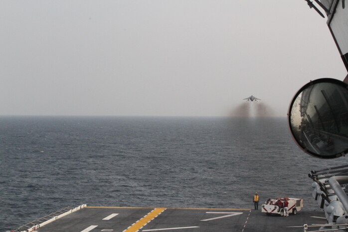 An AV-8B Harrier Jump jet from Marine Medium Tiltrotor Squadron 365 (Reinforced), 24th Marine Expeditionary Unit, takes off from the amphibious assault ship USS Iwo Jima (LHD-7), Jan. 13, 2015. The 24th MEU is embarked on the ships of the Iwo Jima Amphibious Ready Group and deployed to maintain regiaonal security in the U.S. 5th Fleet area of operations (U.S. Marine Corps photo by Lance Cpl. Dani A. Zunun)