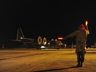 Staff Sgt. Alex Bryden, 901st Aircraft Maintenance Squadron crew chief, marshals in an MC-130H Combat Talon II to its parking spot at Hurlburt Field, Fla., Jan. 8, 2015. The 15th Special Operations Squadron received two Talons from the 7th SOS, RAF Mildenhal, Endgland. (U.S. Air Force photo/Airman 1st Class Jeff Parkinson)