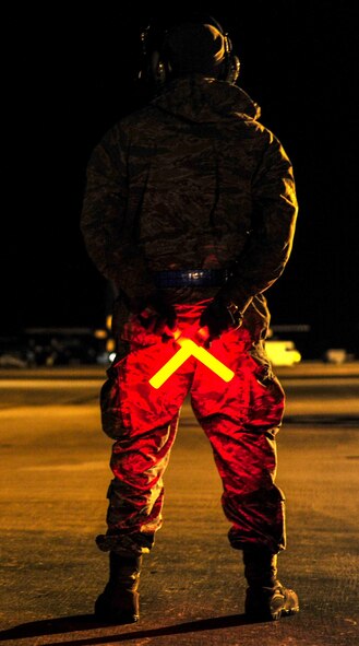 Staff Sgt. Alex Bryden, 901st Aircraft Maintenance Squadron crew chief, waits to marshal an MC-130H Combat Talon II at Hurlburt Field, Fla., Jan. 8, 2014. The 15th Special Operations Squadron received two Talons from the 7th SOS, RAF Mildenhal, Endgland. (U.S. Air Force photo/Airman 1st Class Jeff Parkinson)