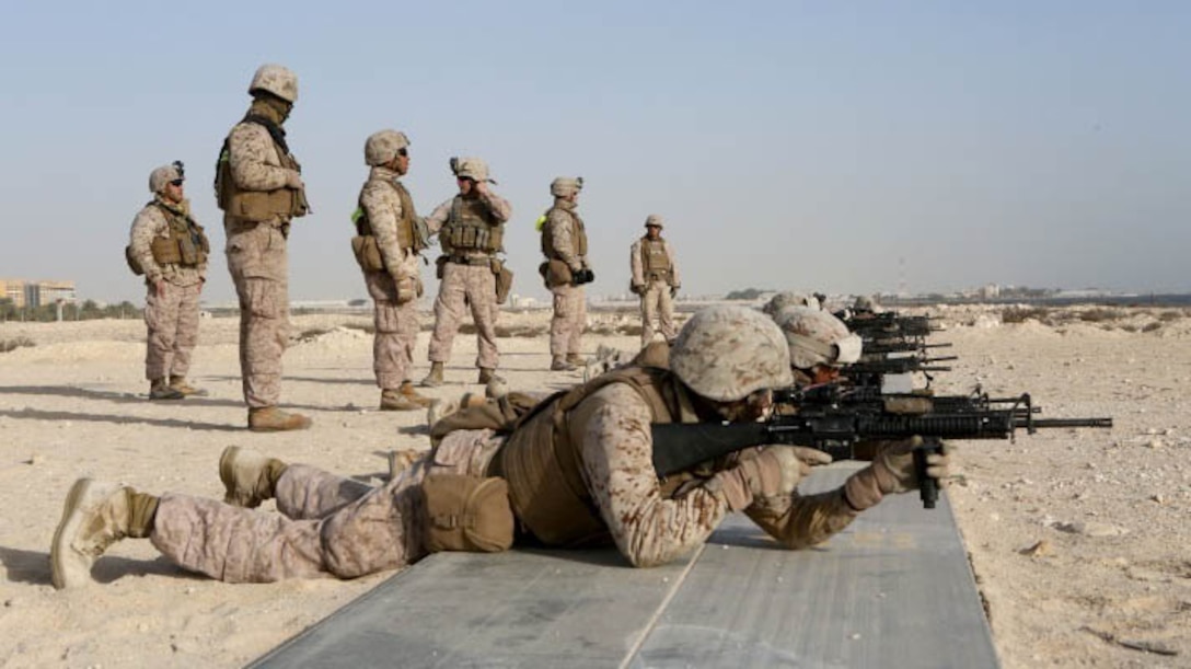 U.S. Marines with 2nd Platoon, Bravo Battery, 3rd Low Altitude Air Defense Battalion and Security Forces, Special Purpose Marine Air Ground Task Force-Crisis Response-Central Command (SPMAGTF-CR-CC), prepare their rifles before a live fire and maneuver exercise Jan. 11, 2015, in the U.S. Central Command area of responsibility. The live fire exercise was conducted to prepare for a future, larger-scale range to help keep SPMAGTF-CR-CC’s Security Forces primed and ready if called to action. 