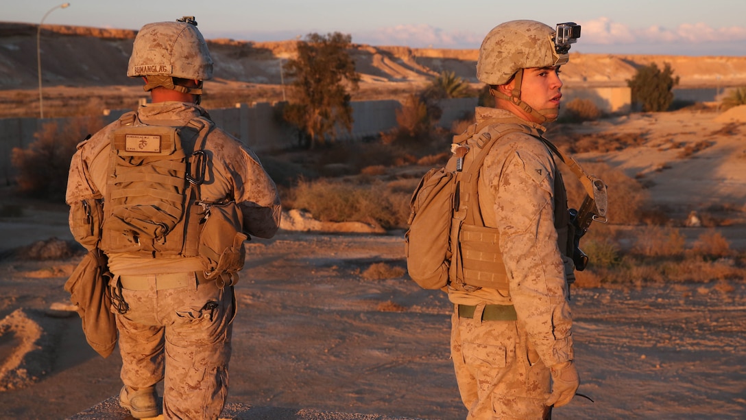 U.S. Marine Cpl. Michael Bumanglag (left) and Lance Cpl. Erik Delgadillo (right), with Special Purpose Marine Air Ground Task Force - Crisis Response - Central Command, Task Force Al Asad, search for the impact site of a 122 mm rocket aboard Al Asad Airbase, Iraq, Jan. 4, 2015. Soldiers and Marines are taking prudent measures to protect the members of Task Force Al Asad from the threat of indirect fire. 