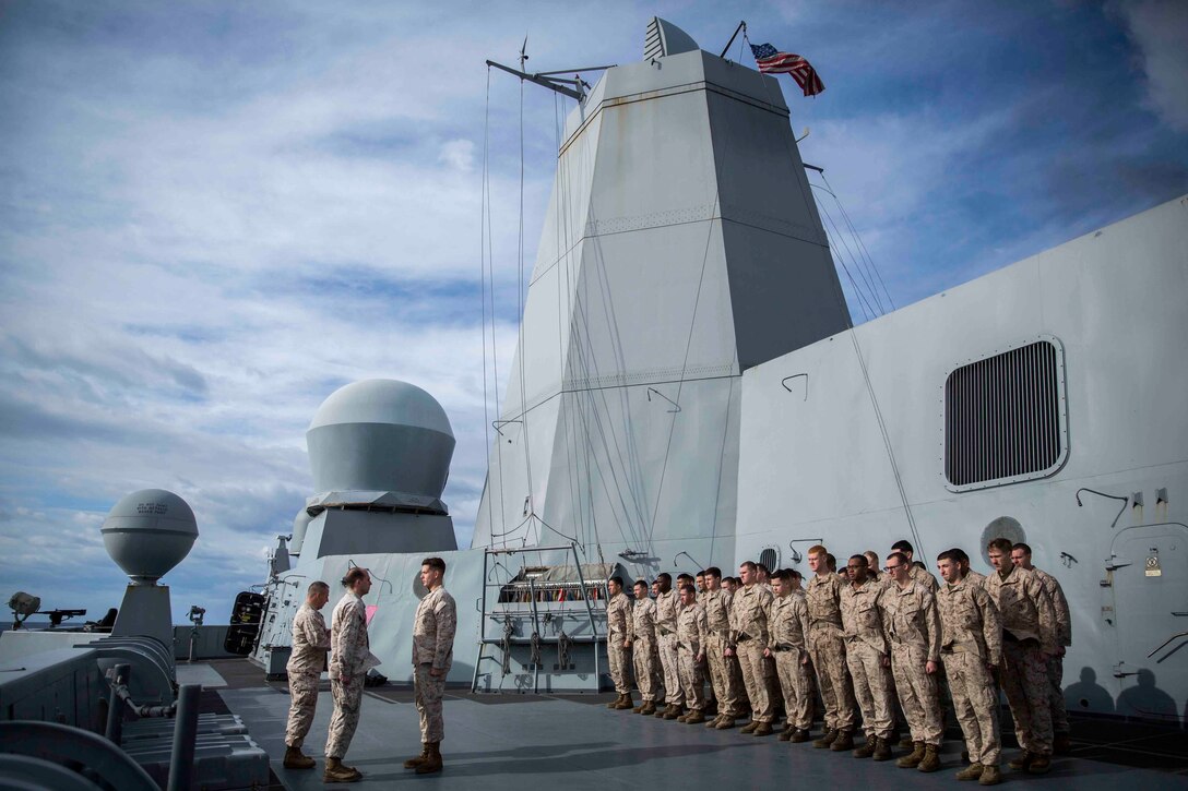 Marines with Combat Logistics Battalion 24, 24th Marine Expeditionary Unit, stand in formation during a promotion ceremony aboard the USS New York, at sea, Jan. 10, 2015. The 24th MEU and Iwo Jima Amphibious Ready Group are conducting naval operations in the U.S. 6th Fleet of operations in support of U.S. national security interests in Europe. (U.S. Marine Corps photo by Cpl. Todd F. Michalek)