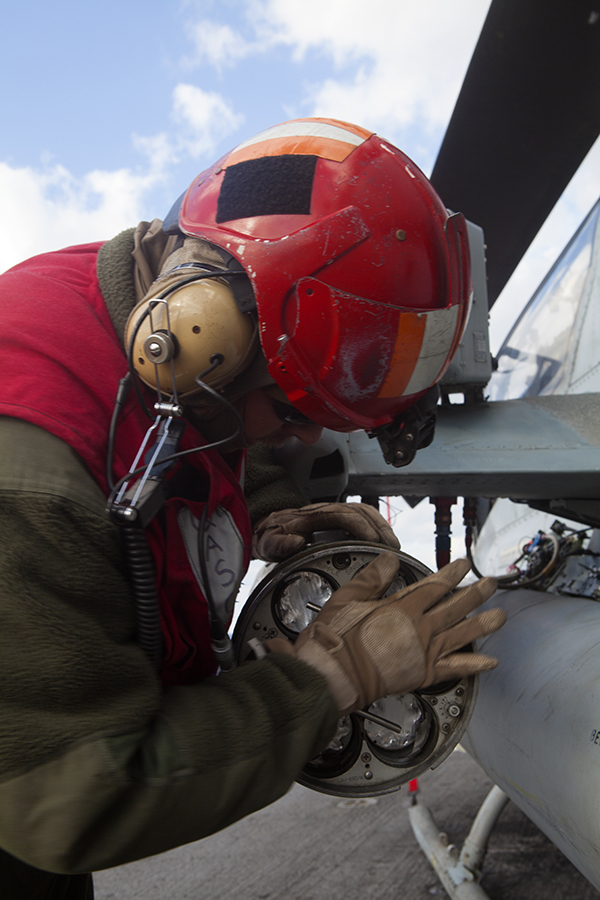 A Marine with Marine Medium Tiltrotor Squadron 365 (Reinforced), 24th Marine Expeditionary Unit (MEU), seals the rear end of an LAU-68 rocket pod attached to an AH-1W Super Cobra aboard USS Iwo Jima (LPD 7), Jan. 7, 2015. The 24th MEU and Iwo Jima Amphibious Ready Group are conducting naval operations in the U.S. 6th Fleet area of operations in support of U.S. national security interests in Europe. (U.S. Marine Corps photo by Lance Cpl. Austin A. Lewis/Released)