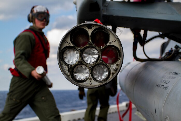 Corporal Stephen Cusson, an aviation ordnance technician assigned to the Marine Medium Tiltrotor Squadron 365 (Reinforced), 24th Marine Expeditionary Unit, loads a 2.75-inch rocket in to a LAU-68 rocket pod attached to an AH-1W Cobra attack helicopter aboard USS Iwo Jima (LPD 7) Jan. 7, 2015. The 24th MEU and Iwo Jima Amphibious Ready Group are conducting naval operations in the U.S. 6th Fleet area of operations in support of U.S. national security interests in Europe. (U.S. Marine Corps photo by Lance Corporal Dani A. Zunun/Released)