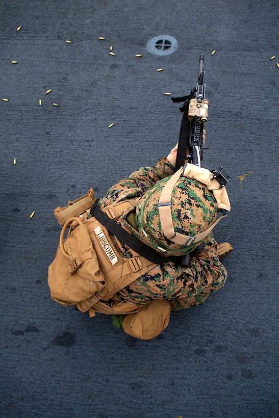 Lance Cpl. Collins Lipscomb, an infantry rifleman assigned to Lima Company, Battalion Landing Team 3rd Battalion, 6th Marine Regiment, 24th Marine Expeditionary Unit, fires his M16A4 service rifle during a live-fire exercise on the flight deck aboard USS Iwo Jima Jan. 4, 2015. The 24th MEU and Iwo Jima Amphibious Ready Group are conducting naval operations in the U.S. 6th Fleet area of operations in support of U.S. national security interests in Europe. (U.S. Marine Corps photo by Lance Cpl. Austin A. Lewis/Released)