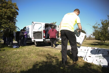 Volunteers at Second Harvest Food Bank in Belle Chasse, La. Package kumquats and load them onto a van for shipment Saturday, Jan. 17, 2015. Marines and Sailors from Marine Forces Reserve and Naval Air Station Joint Reserve Base New Orleans gathered with local community members to harvest a citrus orchard, where the fruit was then packaged for distribution to food banks, pantries and shelters across south Louisiana. Since the beginning of 2015, MARFORRES volunteers have completed 211 service hours in eight different community service projects.  (U.S. Marine Corps photo by Cpl. Tiffany Edwards)