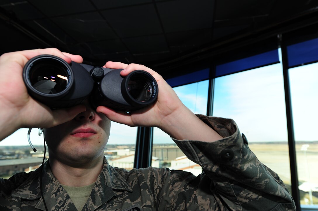 U.S. Air Force Senior Airman Joshua Shaffer, 1st Operations Support Squadron air traffic controller, looks out for an aircraft set to land at Langley Air Force Base, Va., Jan. 20, 2015. The Langley AFB control tower supports the 1st Fighter Wing flying mission in addition to NASA, transient aircraft, Fort Eustis aircraft and distinguished visitor aircraft flying missions. In fiscal year 2014, the tower supported 28,000 flying missions. (U.S. Air Force photo by Staff Sgt. Natasha Stannard/Released)
