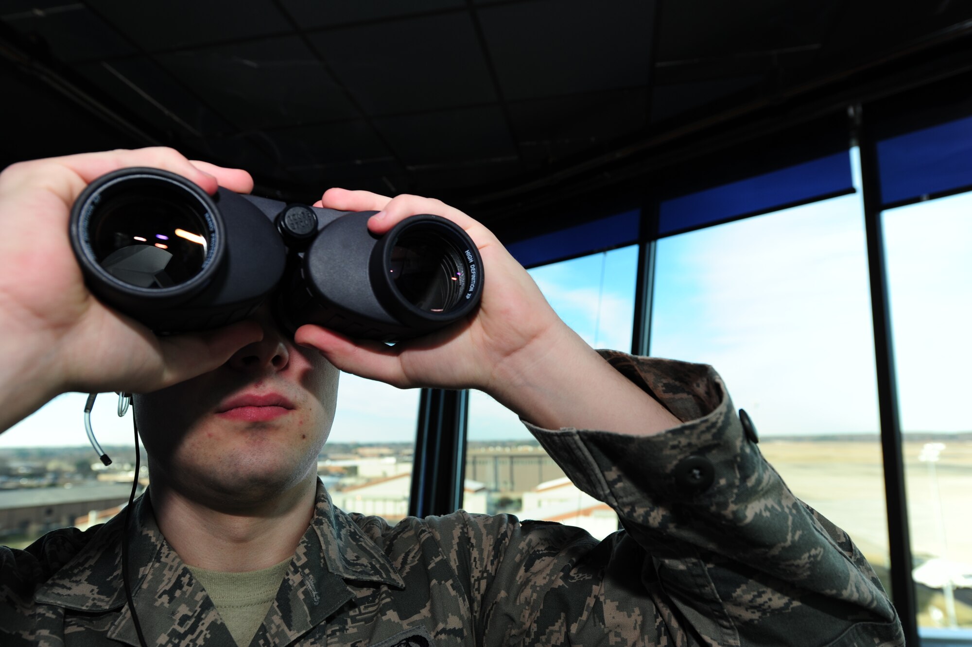 U.S. Air Force Senior Airman Joshua Shaffer, 1st Operations Support Squadron air traffic controller, looks out for an aircraft set to land at Langley Air Force Base, Va., Jan. 20, 2015. The Langley AFB control tower supports the 1st Fighter Wing flying mission in addition to NASA, transient aircraft, Fort Eustis aircraft and distinguished visitor aircraft flying missions. In fiscal year 2014, the tower supported 28,000 flying missions. (U.S. Air Force photo by Staff Sgt. Natasha Stannard/Released)