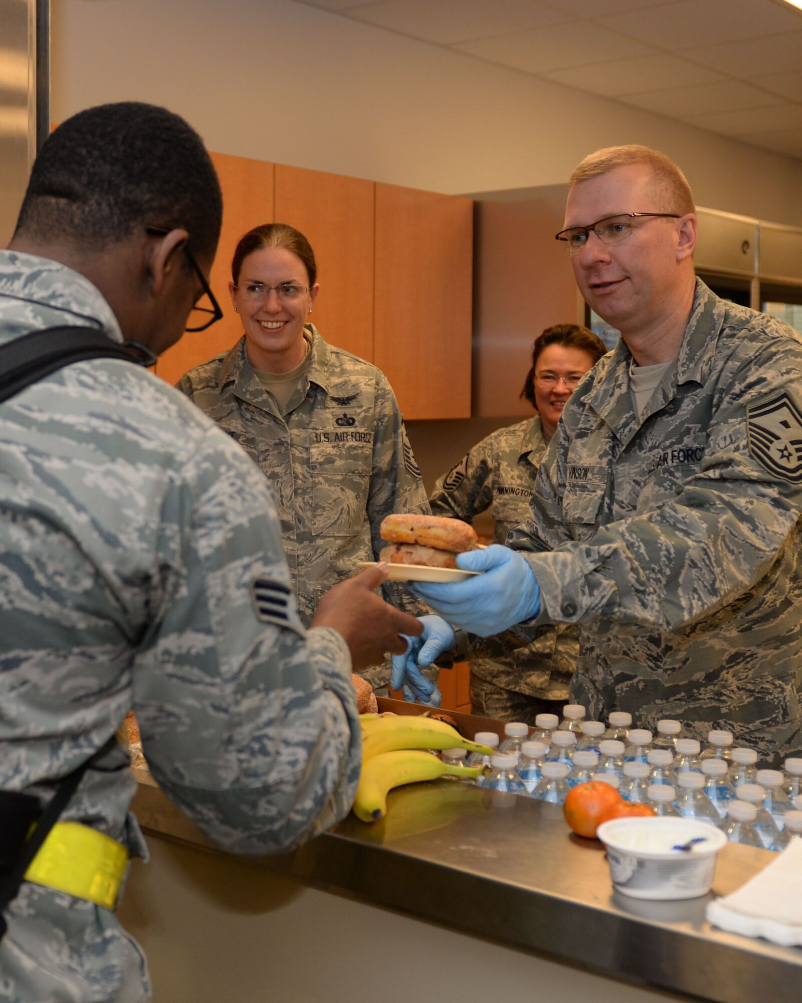 Ellsworth first sergeants serve food and drinks to deploying Airmen in the deployment center at Ellsworth Air Force Base, S.D., Jan. 20, 2015. Airmen will perform a wide range of tasks while deployed such as precision strike and surveillance and reconnaissance capabilities. (U.S. Air Force photo by Airman 1st Class Rebecca Imwalle/Released)