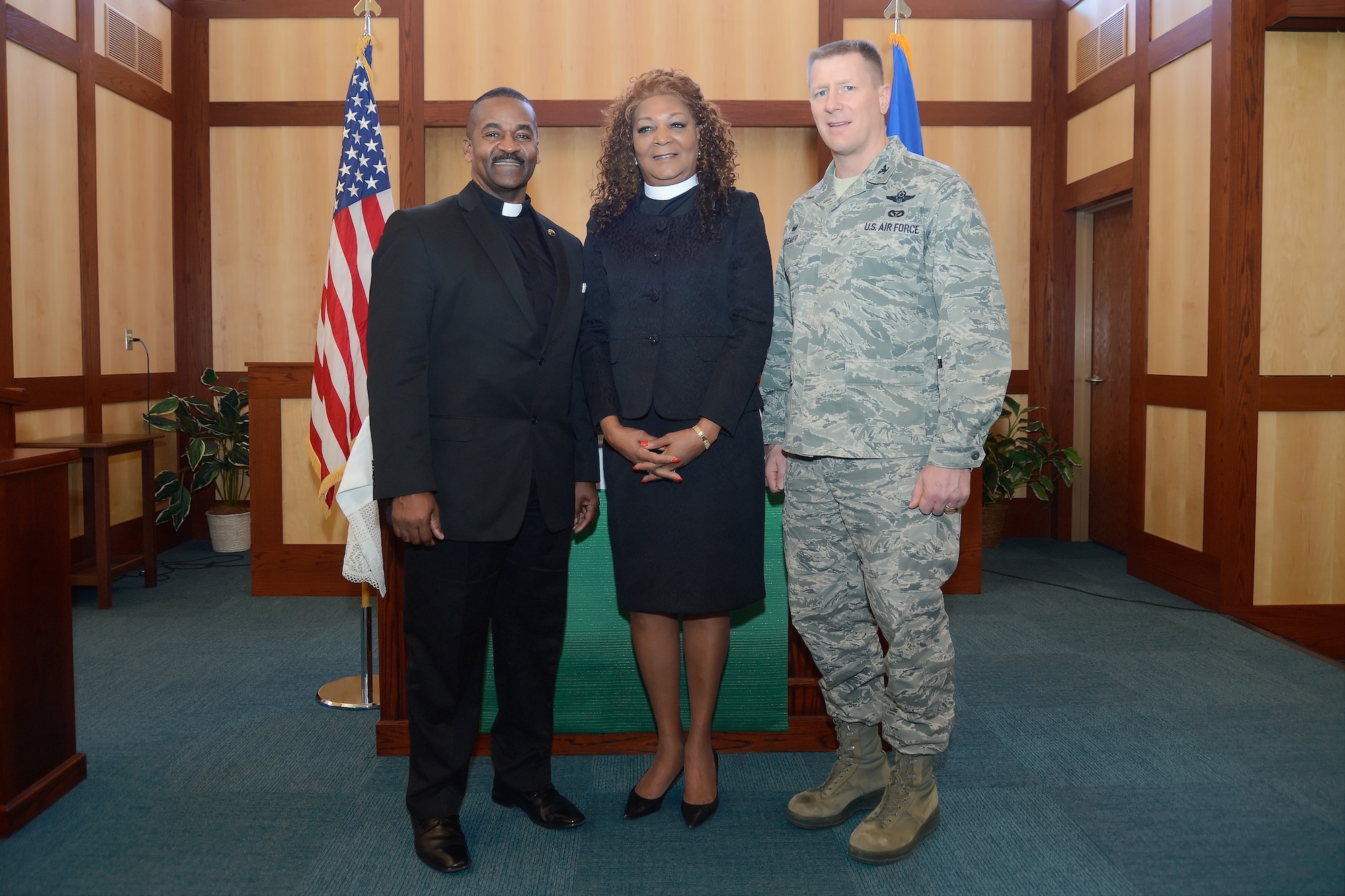 Col. Michael W. Grismer Jr., 436th Airlift Wing commander, is joined by Rev. Annmarie Moore-Handley, center, and Rev. Dr. John Moore Sr., for a group photo following the Dr. Martin Luther King Jr. Day Commemoration Service held at the Dover Air Force Base, Del. main chapel on Jan. 15, 2015. All three spoke during the ceremony that was held in recognition of the holiday. (U.S. Air Force photo/Greg L. Davis)