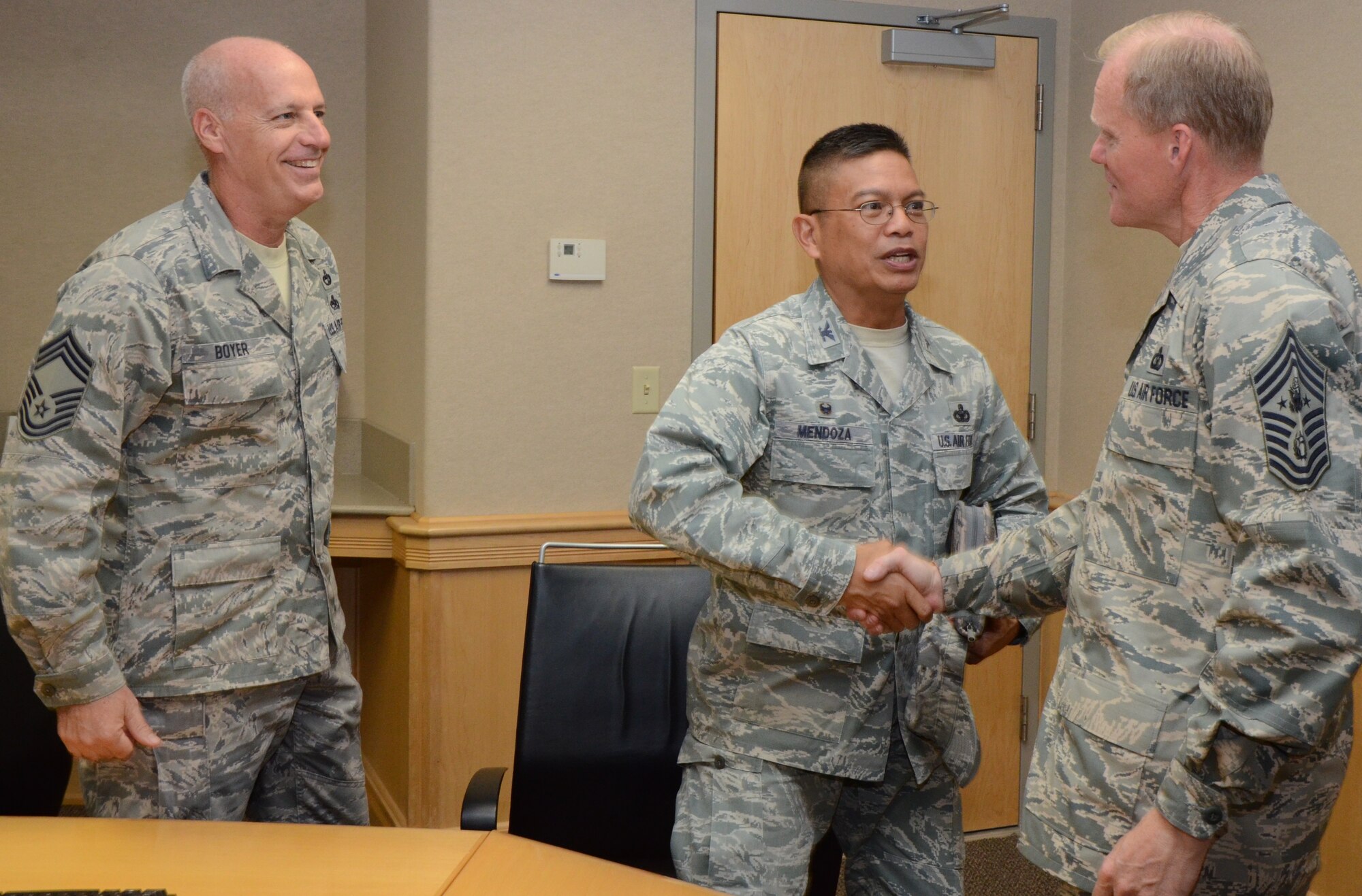 Col. Maynard "Max" Mendoza, center, commander of the 624th Regional Support Group, shakes hands with Chief Master Sgt. of the Air Force James Cody, after he and Chief Master Sgt. Gregory Boyer, left, chief enlisted manager for the 48th Aerial Port Squadron, met with Chief Cody at the Aloha Conference Center, to discuss the Air Force Reserve role in total force integration, Joint Base Pearl Harbor-Hickam, Hawai'i, Jan. 16, 2015. Colonel Mendoza and Chief Boyer have more than 50 years of combined experience in the active duty and Air Force Reserve. (U.S. Air Force photo by Tech. Sgt. Phyllis Keith)