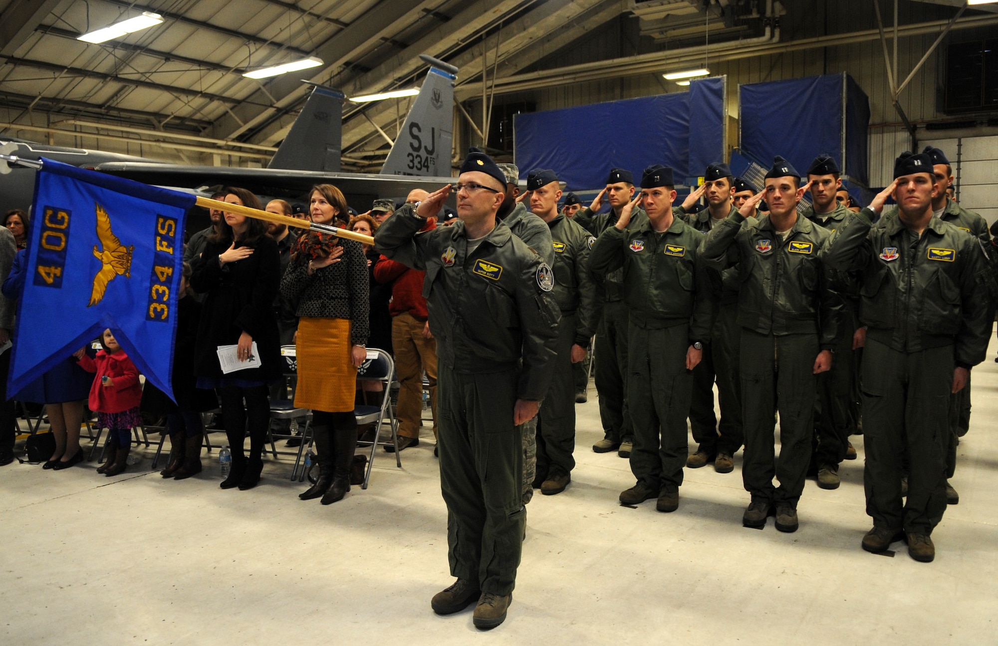 Members of the 334th Fighter Squadron salute the colors in formation during a change of command ceremony at Seymour Johnson Air Force Base, North Carolina, Jan. 16, 2015. Lt. Col. Donn Yates, 334th FS outgoing commander, relinquished command to Lt. Col. Nathan Mead, 334th FS incoming commander during the ceremony. Base and community leadership, along with friends and family of the squadron’s incoming and outgoing commanders, gathered to witness the traditional passing of the guidon. (U.S. Air Force photo/Senior Airman Ashley J. Thum)