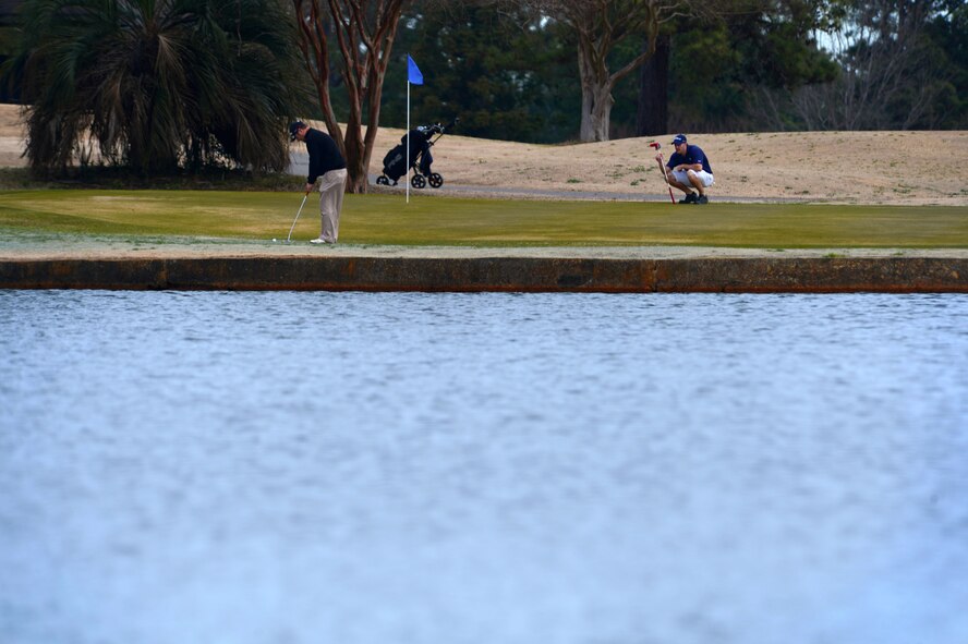 (From left) Retired U.S. Navy Chief Warrant Officer Robin Terrell and U.S. Air Force Lt. Col. Alan Wade, 28th Test Squadron commander assigned to Eglin Air Force Base, Fl., play golf on the 20th Force Support Squadron Carolina Lakes golf course at Shaw Air Force Base, S.C., Jan. 20, 2015. Featuring one of the longest holes in the state, the 18-hole course is open year round. (U.S. Air Force photo by Senior Airman Jensen Stidham/Released)