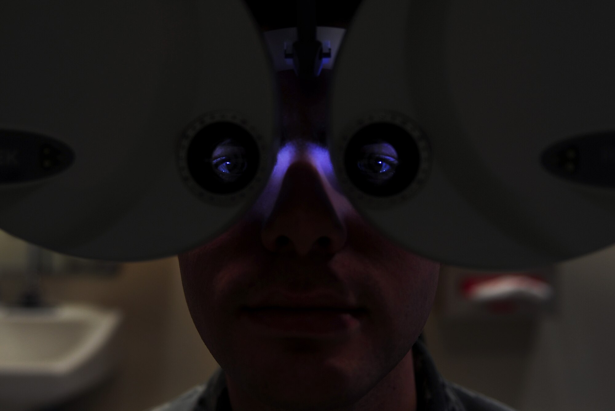 U.S. Air Force Senior Airman Cole Bonack’s, 633rd Aerospace Medicine Squadron Optometry technician, eyes are tested with a phoropter at Langley Air Force Base, Va., Jan. 16, 2015.  The Langley Optometry Clinic uses a phoropter, which contains different lenses, to determine a patient’s glasses prescription. (U.S. Air Force photo by Airman 1st Class Areca T. Wilson/Released) 