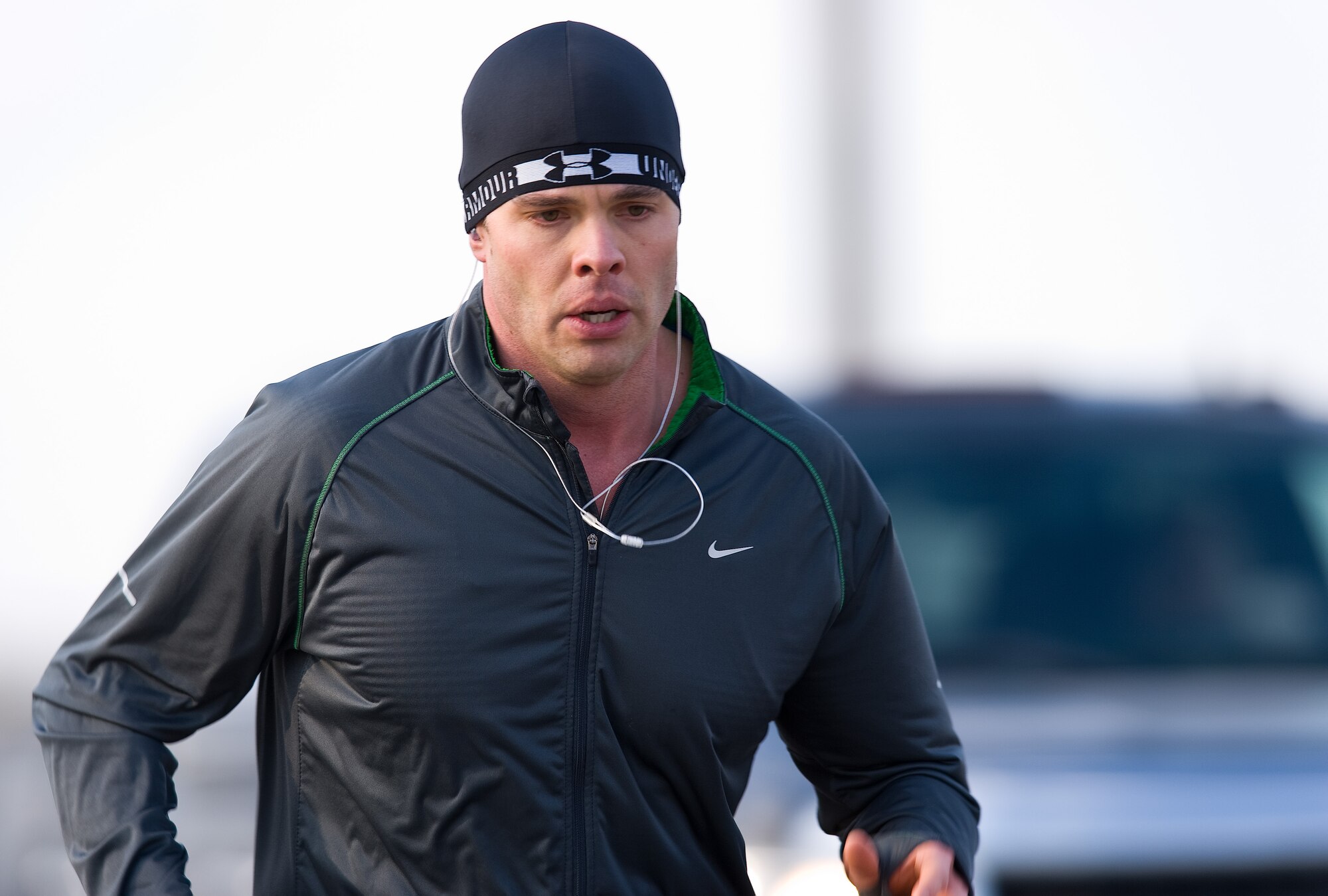 Capt. Zach Walrond, 3rd Airlift Squadron pilot and training flight commander, runs south on Atlantic Street towards the Fitness Center during the New Year New You warrior run Jan. 16, 2015, at Dover Air Force Base, Del. Waldron finished second among 210 runners and completed the 2.7 mile warrior run in 15 minutes and 22 seconds.  (U.S. Air Force photo by Roland Balik)