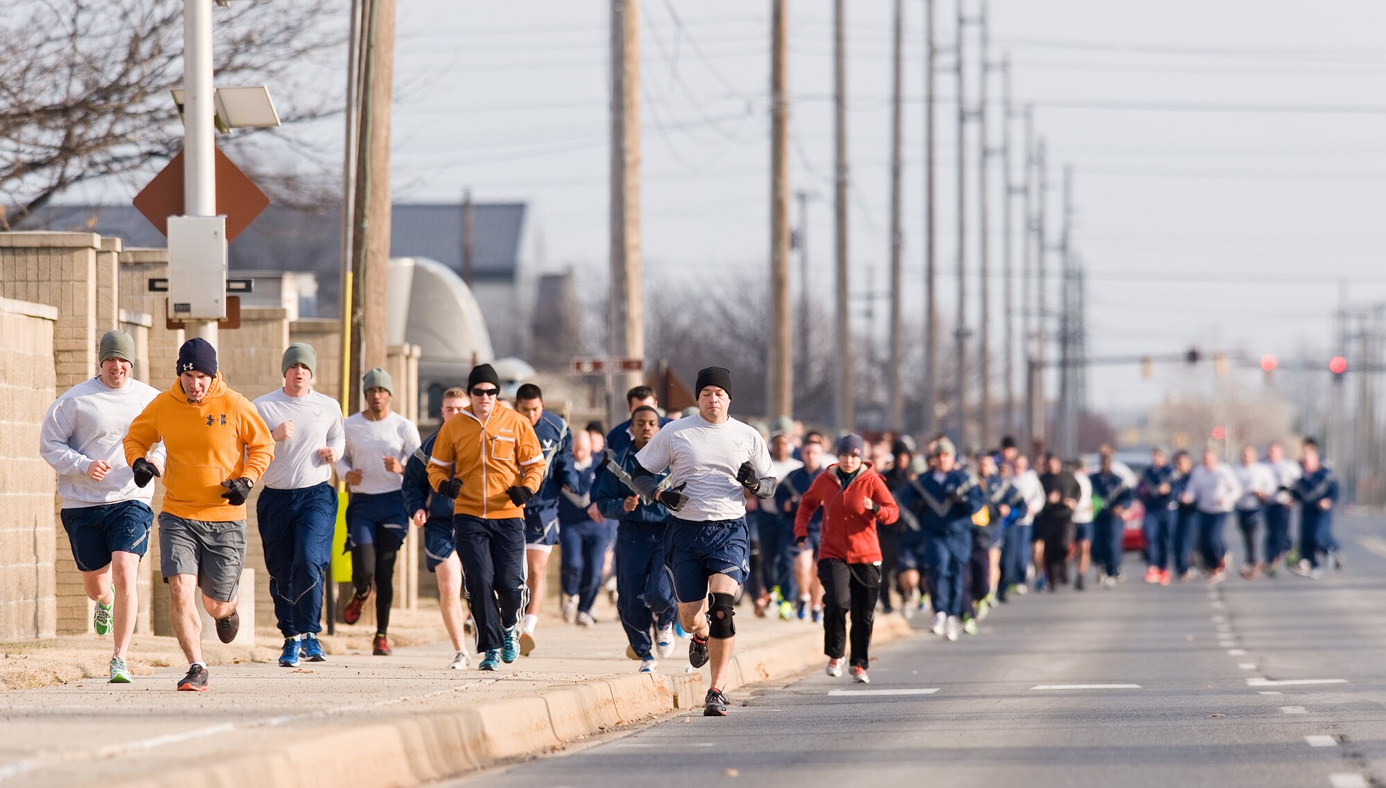 Runners pace themselves heading north on Atlantic Street during the New Year New You warrior run Jan. 16, 2015, at Dover Air Force Base, Del. More than 200 runners took part in the 2.7 mile run that was won by Senior Airman Steven Gray, 736th Aircraft Maintenance Squadron, in 15 minutes and 10 seconds.  (U.S. Air Force photo by Roland Balik)