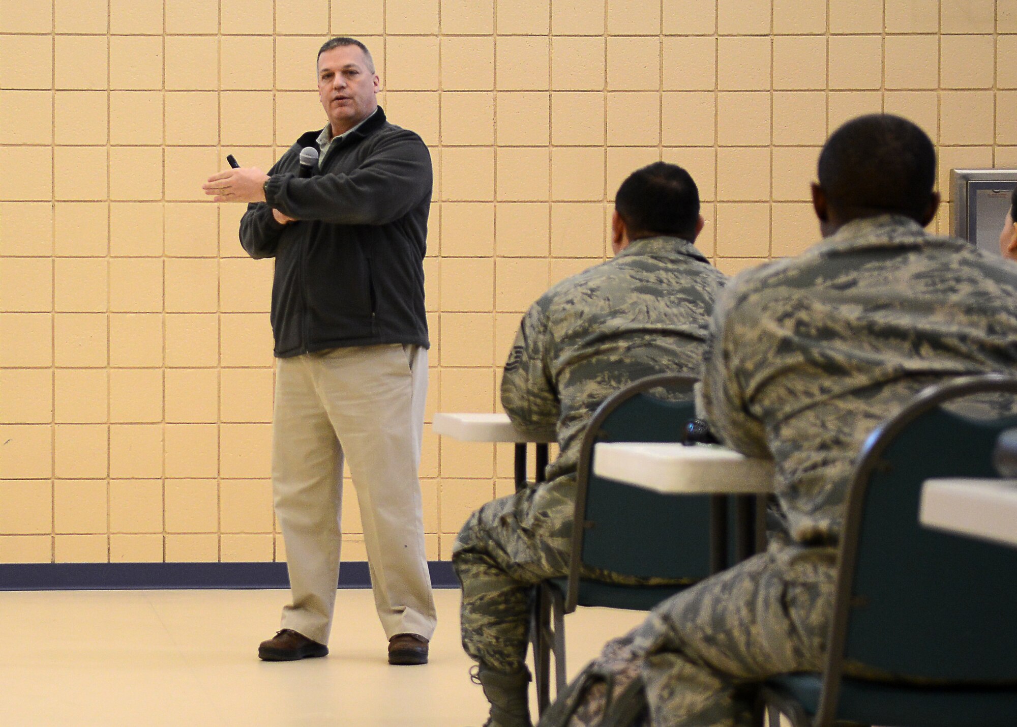 Michael Feckner, 633rd Air Base Wing inspection team manager, speaks to Airmen during a Right Start briefing at Langley Air Force Base, Va., Jan. 20, 2015. As part of the briefing, Feckner spoke about operational security and gave examples of how an adversary might intercept sensitive information. (U.S. Air Force photo by Airman 1st Class Devin Scott Michaels/Released)