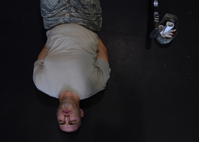 Staff Sgt. Alfredo Caballero, United States Air Force honor guardsman, performs flutter-kicks during USAFHG Drill Team Training at Joint Base Anacostia-Bolling, Md., Jan. 16, 2015. Six trainees volunteer eight, 60-hour weeks to learn weapon maneuvers and calisthenics to gain a spot on the team. (U.S. Air Force photo/ Senior Airman Nesha Humes)