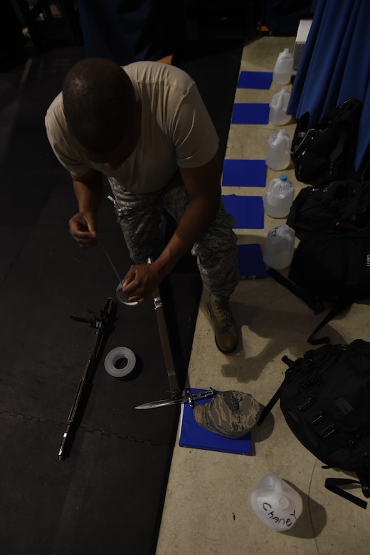 Tech. Sgt. Maurice Chaney, United States Air Force honor guardsman, dissembles and duct-tapes his M1 Garand with a fixed bayonet during USAFHG Drill Team Training at Joint Base Anacostia-Bolling, Md., Jan. 13, 2015. The trainees secure their weapon before every class to keep weapons from dismantling when dropped.  (U.S. Air Force photo/ Senior Airman Nesha Humes)