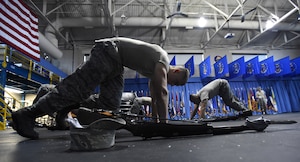 Trainees perform mountain climbers during United States Air Force Honor Guard Drill Team Training at Joint Base Anacostia-Bolling, Md., Jan. 13, 2015. Six trainees volunteer eight, 60-hour weeks to learn to learn weapon maneuvers and calisthenics to gain a spot on the team. (U.S. Air Force photo/ Senior Airman Nesha Humes) 