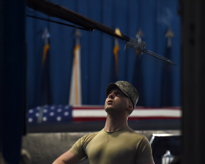 Airman 1st Class Rigby Carter, United States Air Force honor guardsman, throws an M1 Garand with a fixed bayonet into the air during USAFHG Drill Team Training at Joint Base Anacostia-Bolling, Md., Jan. 13, 2015. Six trainees volunteer eight, 60-hour weeks to learn weapon maneuvers and calisthenics to gain a spot on the team. (U.S. Air Force photo/ Senior Airman Nesha Humes)