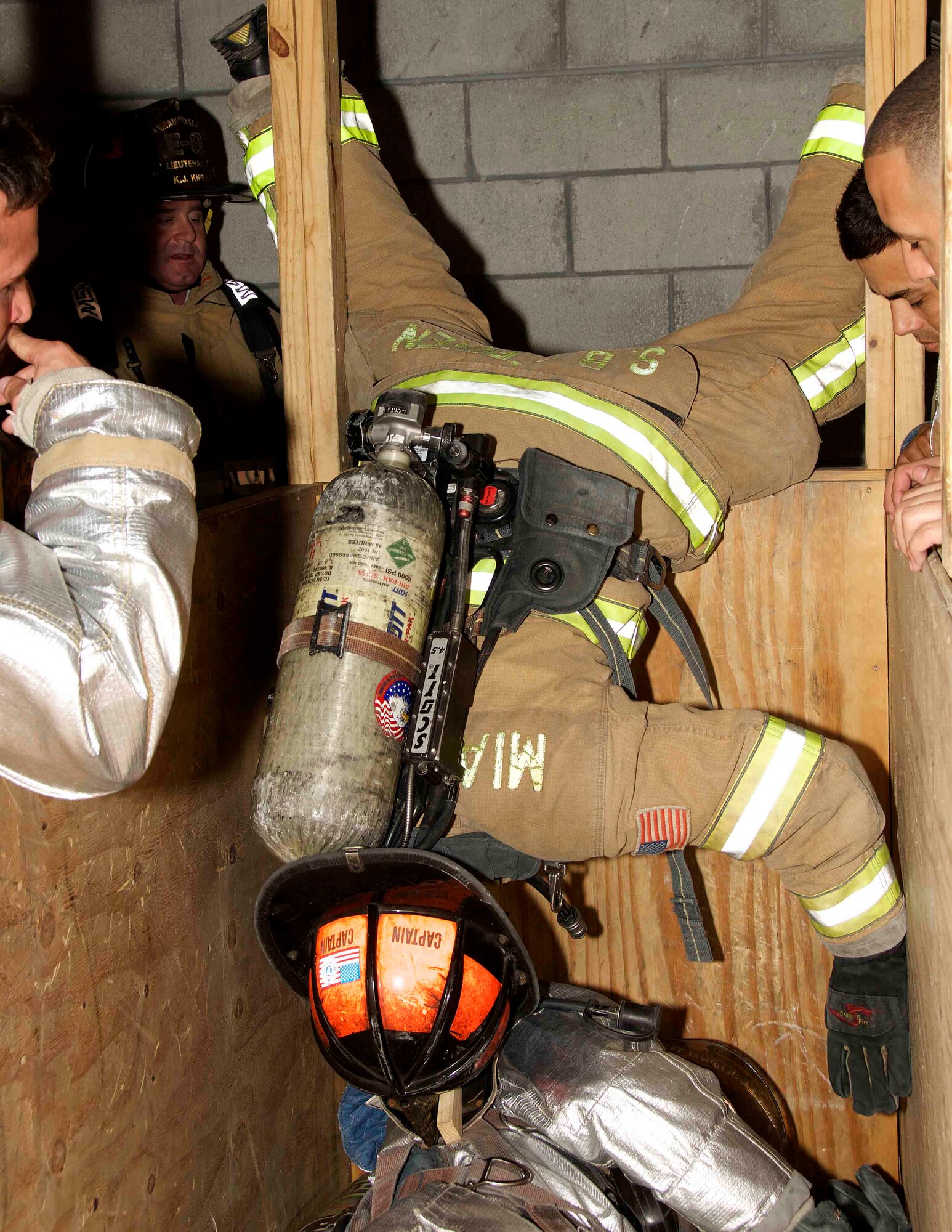 Lt. Kory Kiper, Miami-Dade County fire instructor, demonstrated the Denver Drill for a team of fire protection technicians from the 482nd Prime BEEF (base engineer emergency force) Fire Flight at Homestead Air Reserve Base, Fla., during a training event at the Miami-Dade County Fire Rescue Training Complex in Doral, Fla., Jan. 8. The Denver Drill is a technique created by firefighters to get an unresponsive firefighter out of a confined area. The drill was created in response to a firefighter that died in Denver due to similar circumstances. (U.S. Air Force photo by Senior Airman Jaimi L. Upthegrove)