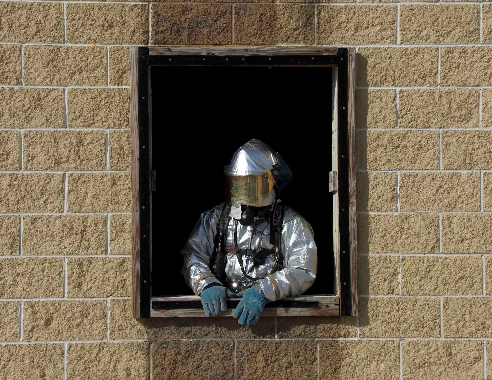Senior Airman Julio C. Soza, 482nd Prime BEEF (base engineer emergency force) Fire Flight fire protection technician at Homestead Air Reserve Base, Fla., knocked out a window during a training at the Miami-Dade County Fire Rescue Training Complex in Doral, Fla., Jan. 8. By taking out the window he provided more airflow and an immediate means of egress in case his team needs to get out of the building quickly. (U.S. Air Force photo by Senior Airman Jaimi L. Upthegrove)