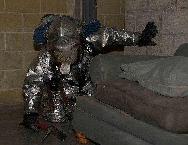 Senior Airman Angelo Viniegra, 482nd Prime BEEF (base engineer emergency force) Fire Flight fire protection technician at Homestead Air Reserve Base, Fla., blindly navigates through a mock apartment as part of a training at the Miami-Dade County Fire Rescue Training Complex in Doral, Fla., Jan. 8. The training provided the Airman an opportunity to get first-hand experience and mentorship from seasoned firefighters. (U.S. Air Force photo by Senior Airman Jaimi L. Upthegrove)