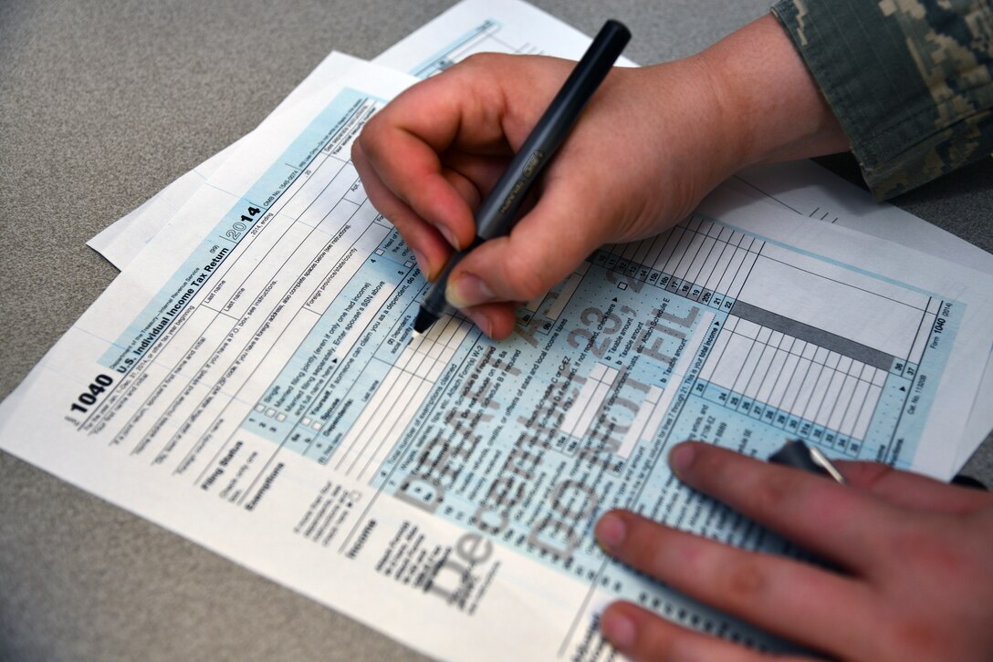 A U.S. Air Force reviews a form 1040, U.S. Individual Tax Return, at Langley Air Force Base, Va., Feb. 5, 2013. Joint Base Langley-Eustis tax centers are set to open Feb. 2, for the 2015 income tax season. (U.S. Air Force photo illustration by Senior Airman Aubrey White/ Released)