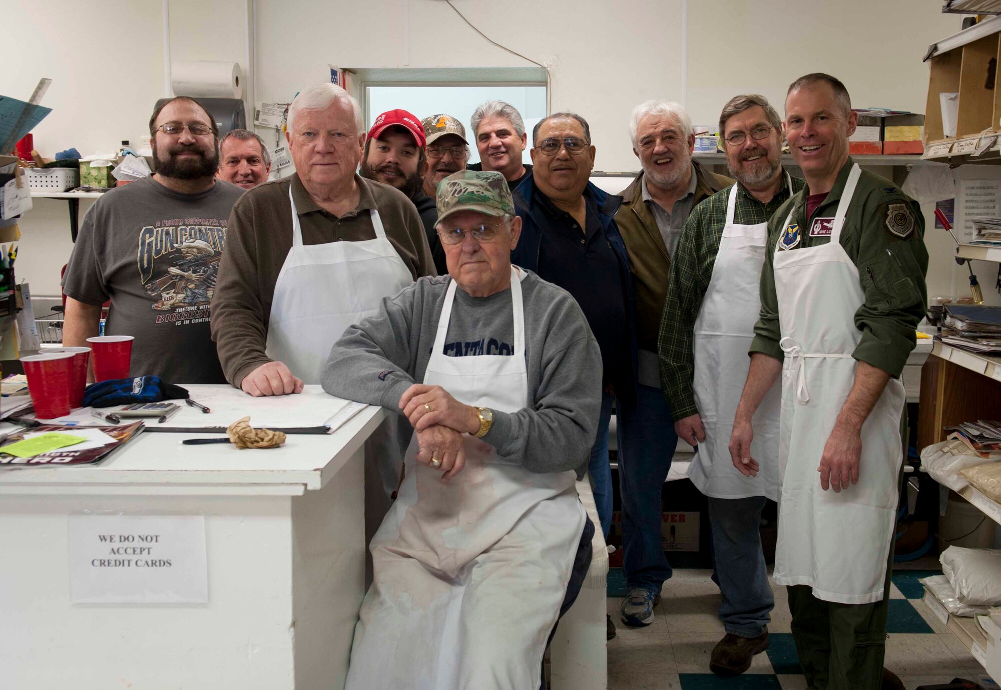 Col. Michael Lutton, 91st Missile Wing commander, poses with community members in Minot, N.D., Jan. 16, 2014. Lutton helped cut and prepare meat for the 50th annual Sportsmen’s Feed held on Minot Air Force Base. (U.S. Air Force photo/Airman 1st Class Sahara L. Fales)