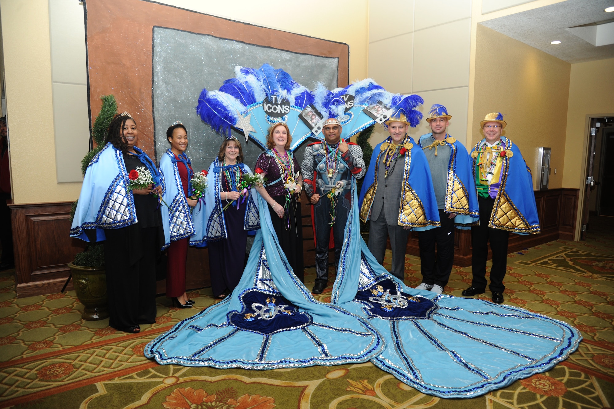 The 2015 Krewe of Medics royalty and court pose for a group photo during the Keesler Medical Center’s 27th annual Krewe of Medics Mardi Gras Ball Jan. 17, 2015, at the Bay Breeze Event Center, Keesler Air Force Base, Miss.  The Krewe of Medics hosts a ball every year to give military personnel assigned to the Keesler Medical Center a taste of the South and an opportunity to experience a traditional Mardi Gras.  The theme of this year's ball was TV Icons. Maj. Marlon Muthuveeran, 81st Medical Support Squadron medical readiness flight commander was crowned King and Sarah Jacobs, Krewe of Medic member, was crowned Queen. (U.S. Air Force photo by Kemberly Groue)