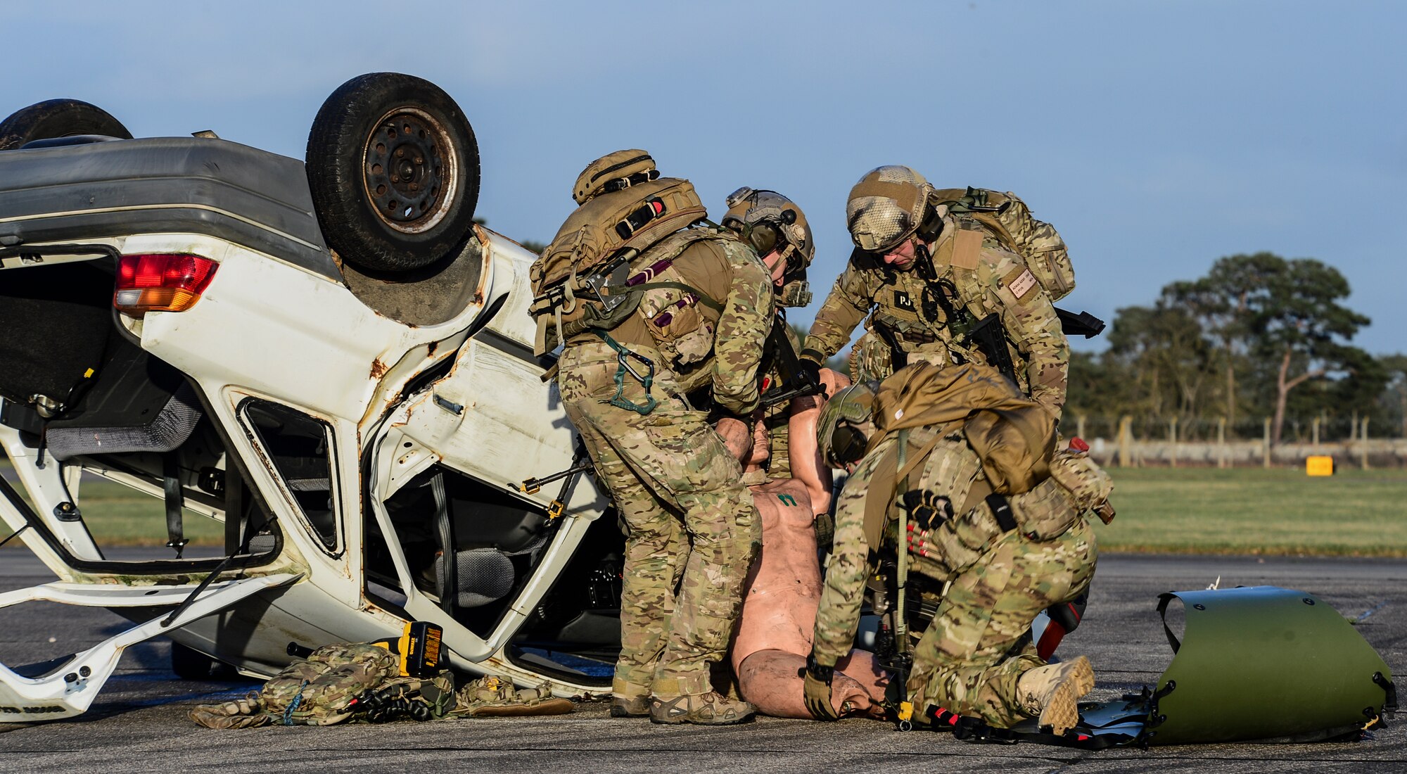Four pararescueman assigned to the 56th Rescue Squadron evactuate a simulated wounded person during a combat search and rescue scenario at Royal Air Force Lakenheath, England, Jan. 16, 2015. The CSAR demonstration was part of an Installation Excellence Selection Board visit to determine the winner of the Commander in Chief’s Annual Award for Installation Excellence. (U.S. Air Force photo by Airman 1st Class Erin R. Babis/Released)